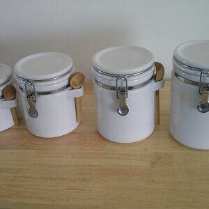 4 piece white ceramic canister set with clamp top lids and original wooden spoon